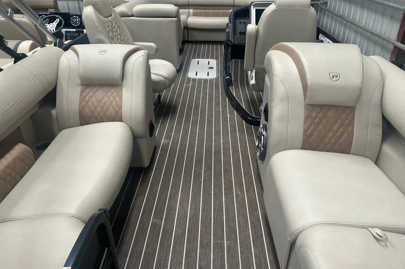 Slide: The Image of Luxurious interior of 2025 Premier 250 Intrigue RF pontoon boat with plush seating. - 10