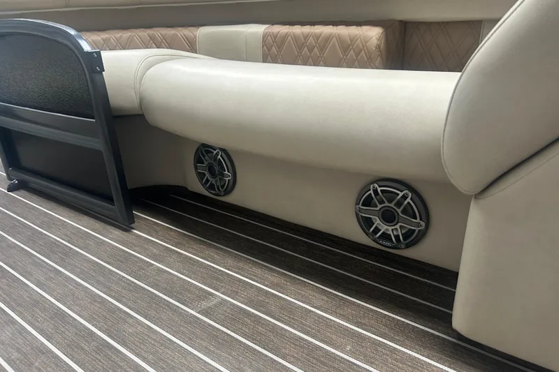 Slide: The Image of 2025 Premier 250 Intrigue RF boat interior with beige seating and built-in speakers. - 16