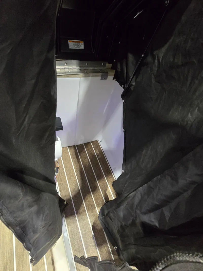 Slide: The Image of Interior view of 2025 Premier Intrigue with wood flooring and black fabric panels. - 18