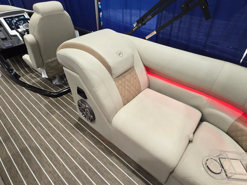 Slide: The Image of Luxurious 2025 Premier Intrigue boat interior with beige seating and ambient red lighting. - 19
