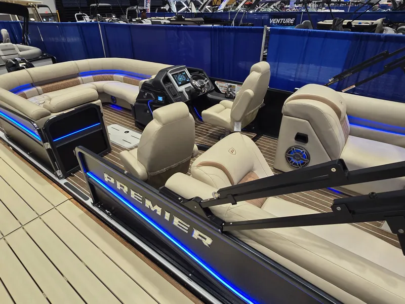 Slide: The Image of 2025 Premier Intrigue boat interior with luxurious seating and modern dashboard. - 2