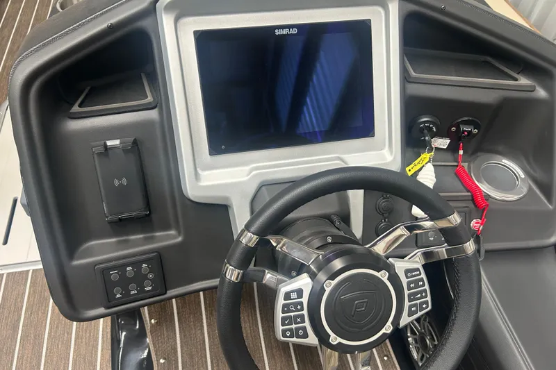 Slide: The Image of 2025 Premier 250 Intrigue RF boat dashboard with steering wheel and digital display. - 29