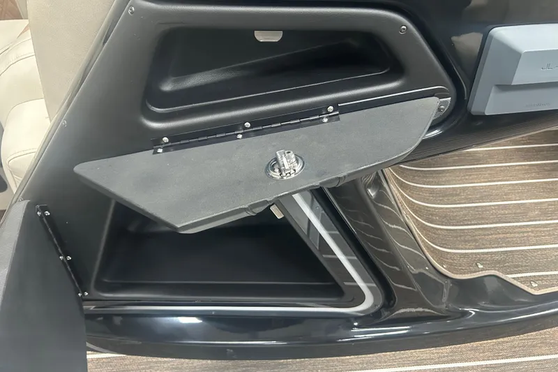 Slide: The Image of 2025 Premier 250 Intrigue RF boat interior storage compartment with sleek design and secure latch. - 32