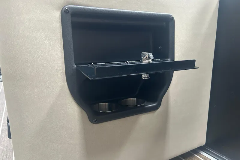 Slide: The Image of 2025 Premier 250 Intrigue RF cup holder with foldable tray in beige interior. - 37