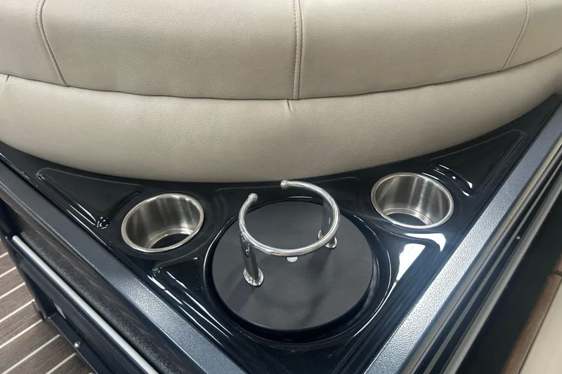 Slide: The Image of Premier 250 Intrigue RF 2025 boat interior with cup holders and beige seating. - 50