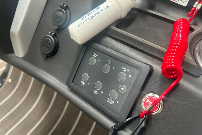Slide: The Image of Control panel of 2025 Premier 250 Intrigue RF boat with red safety cord. - 56