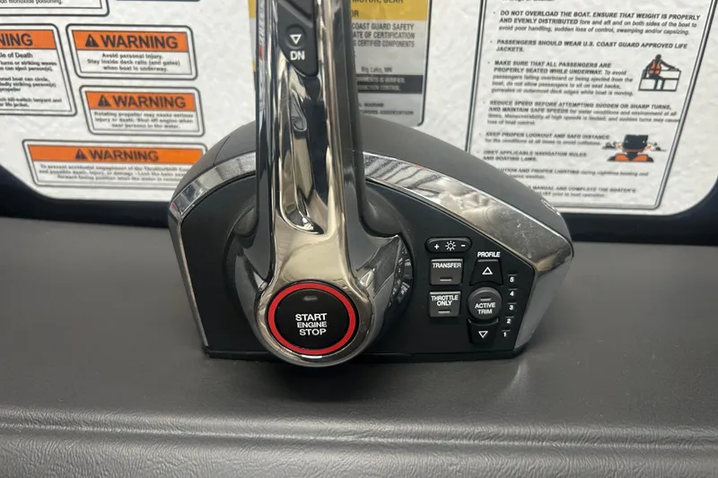 Slide: The Image of Control panel of 2025 Premier 250 Intrigue RF boat with start engine button and warning labels. - 58