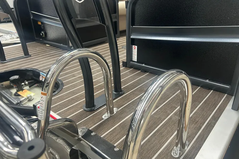 Slide: The Image of 2025 Premier 250 Intrigue RF boat interior with sleek chrome details and striped flooring. - 6