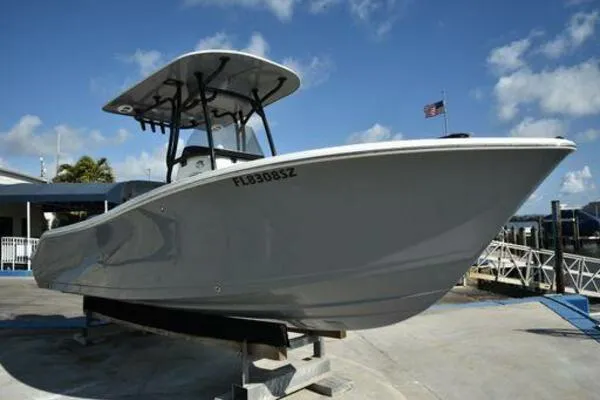 The Image of 2022 NauticStar 2302 Legacy boat on display at a marina. - 0