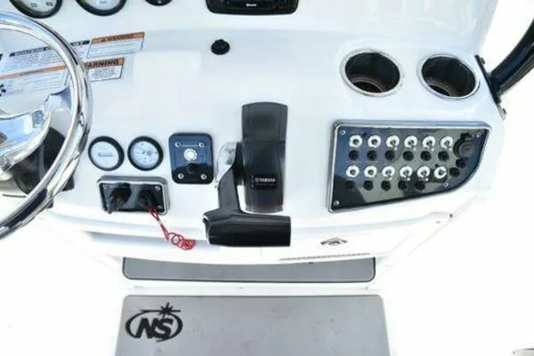 Slide: The Image of Control panel of 2022 NauticStar 2302 Legacy boat with gauges and switches. - 13