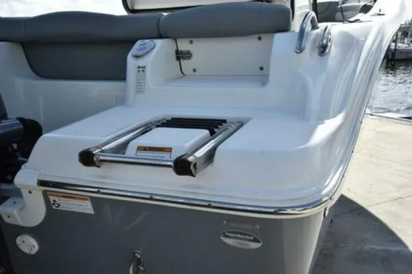 Slide: The Image of 2022 NauticStar 2302 Legacy boat with swim ladder and cushioned seating. - 14
