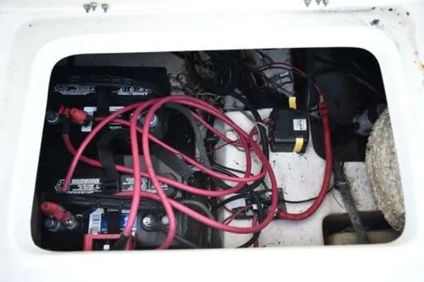 Slide: The Image of Battery compartment of 2022 NauticStar 2302 Legacy with red cables and wiring. - 15