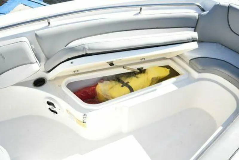 Slide: The Image of 2022 NauticStar 2302 Legacy boat storage compartment with life jacket inside. - 17