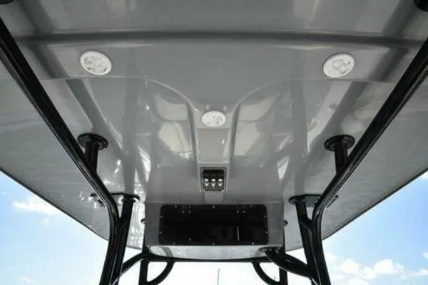 Slide: The Image of 2022 NauticStar 2302 Legacy boat T-top with integrated lighting and sturdy support structure. - 20
