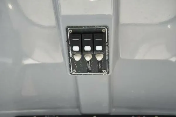 Slide: The Image of Control panel of 2022 NauticStar 2302 Legacy boat with switches. - 21