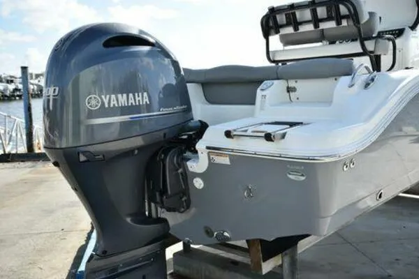 Slide: The Image of 2022 NauticStar 2302 Legacy boat with Yamaha outboard motor, docked at marina. - 4