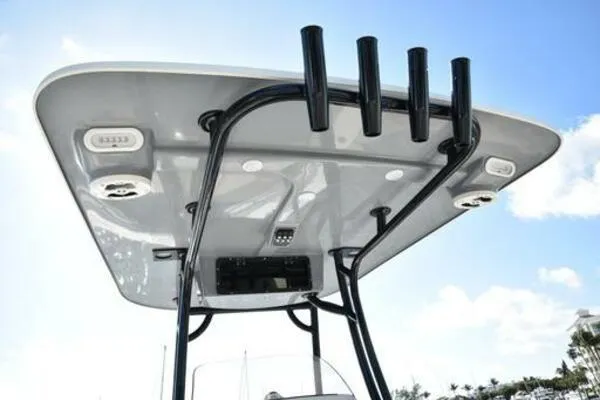 Slide: The Image of T-top of 2022 NauticStar 2302 Legacy boat with rod holders and speakers. - 6