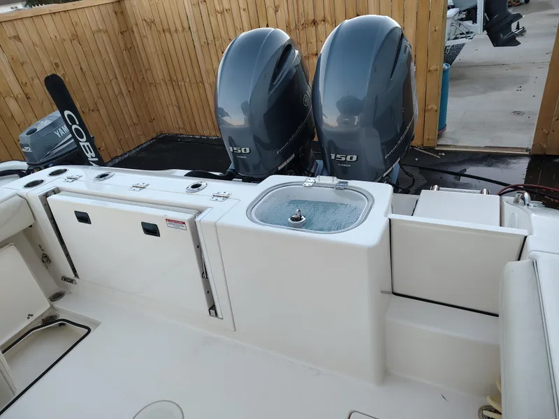 Slide: The Image of 2020 Cobia 240 Center Console boat with dual 150 horsepower engines. - 11