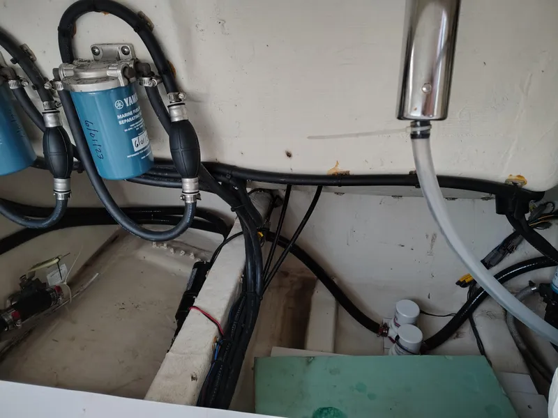 Slide: The Image of Engine compartment of 2020 Cobia 240 Center Console with visible fuel filters and wiring. - 13