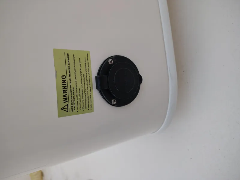 Slide: The Image of Warning label and port on 2020 Cobia 240 Center Console boat. - 14