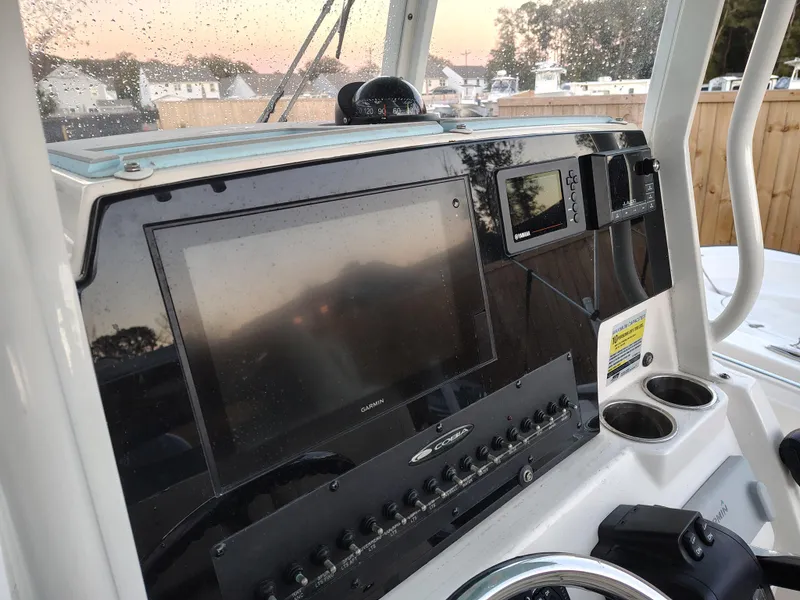 Slide: The Image of Cobia 240 Center Console 2020 dashboard with navigation screens and controls. - 17