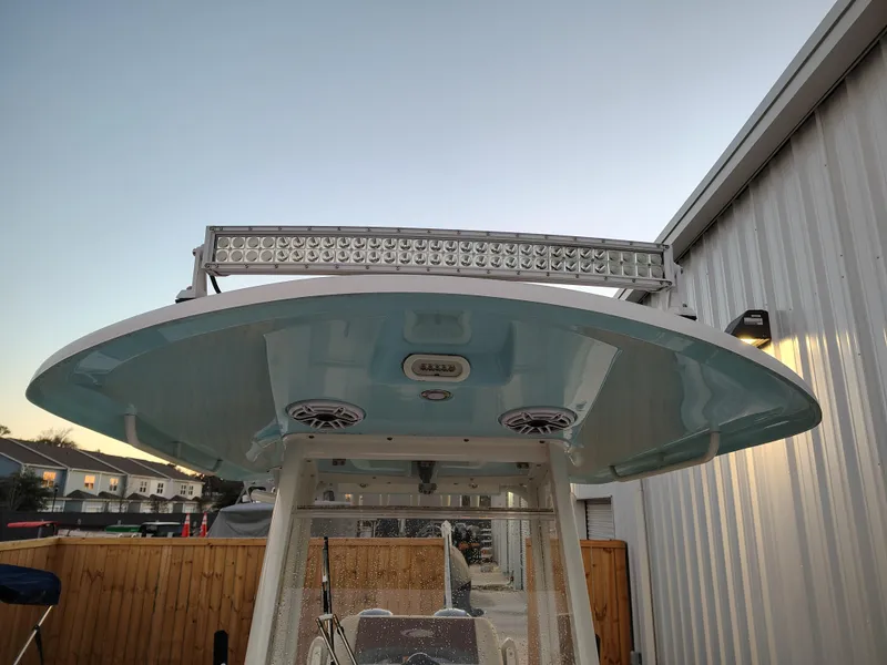 Slide: The Image of 2020 Cobia 240 Center Console boat with T-top and LED light bar. - 21