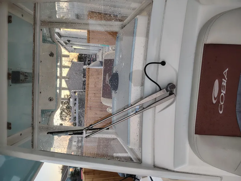 Slide: The Image of 2020 Cobia 240 Center Console boat interior with windshield wiper and Cobia branding. - 22