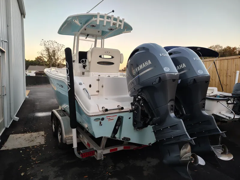 Slide: The Image of 2020 Cobia 240 Center Console boat with dual Yamaha engines on a trailer. - 4