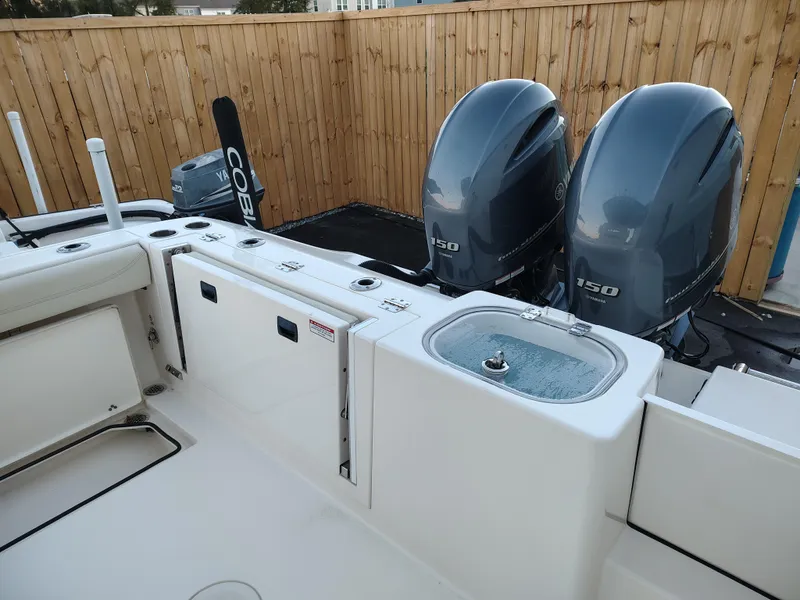 Slide: The Image of 2020 Cobia 240 Center Console boat with dual 150 horsepower engines. - 6