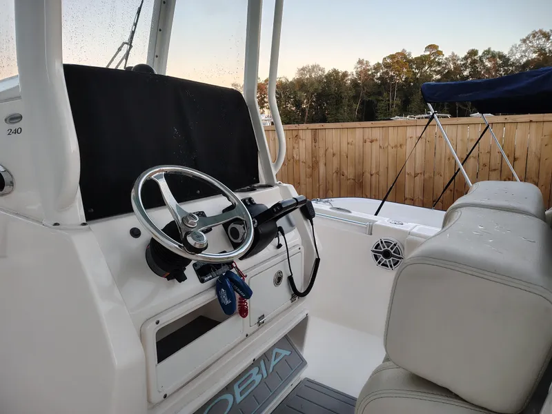 Slide: The Image of 2020 Cobia 240 Center Console boat interior with steering wheel and seating. - 9