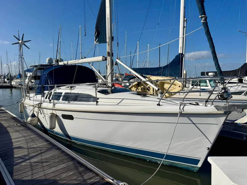 Slide: The Image of Sailboat docked at marina, Hunter 340 model, year 2000, with clear blue sky. - 0