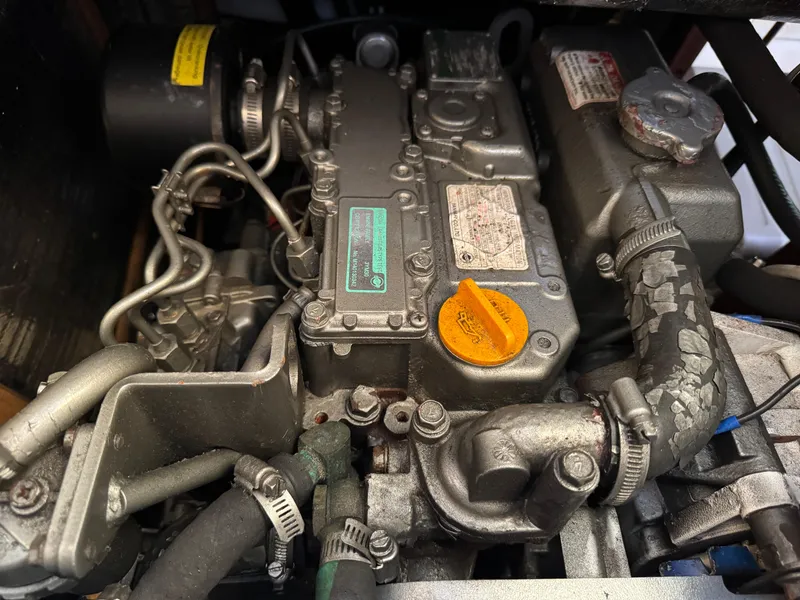 Slide: The Image of Engine of a 2000 Hunter 340 sailboat, showcasing intricate mechanical components. - 11