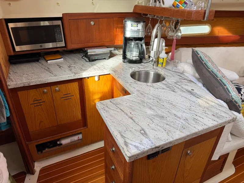 Slide: The Image of Hunter 340 yacht kitchen with granite countertops, microwave, and coffee maker, 2000 model. - 4