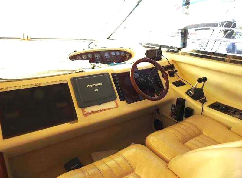 Slide: The Image of Interior of a 1998 Viking Sports Cruiser with steering wheel and navigation equipment. - 13