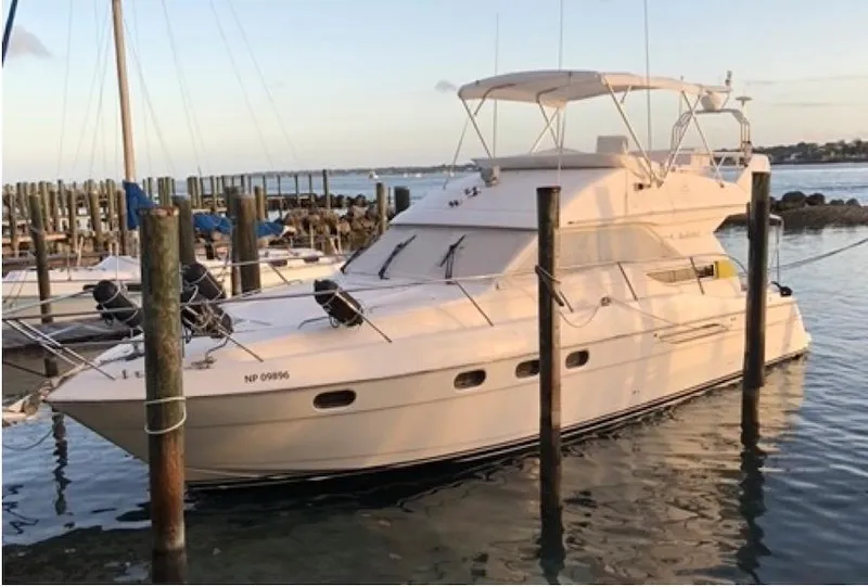 Slide: The Image of 1998 Viking Sports Cruiser docked at marina during sunset. - 15