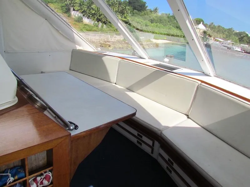 Slide: The Image of Interior of 1972 Hargrave 67 Motor Yacht with white seating and wooden table. - 18