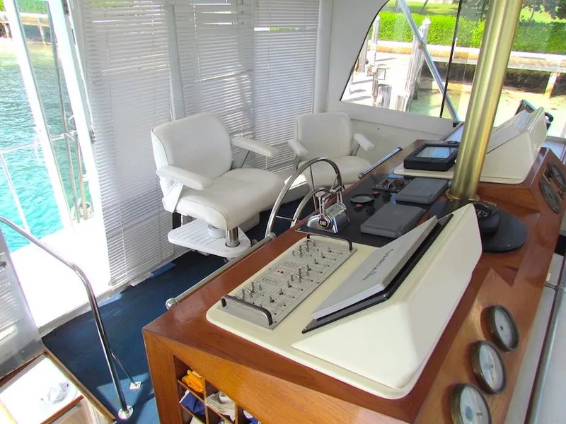 Slide: The Image of Interior helm of 1972 Hargrave 67 Motor Yacht with white chairs and control panel. - 19