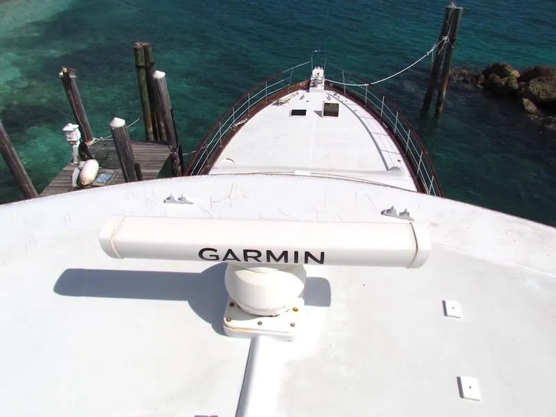 Slide: The Image of Hargrave 67 Motor Yacht 1972 docked, featuring Garmin equipment, with clear blue water background. - 2