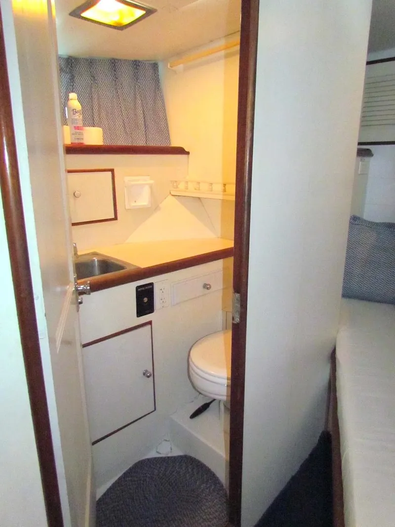 Slide: The Image of 1972 Hargrave 67 Motor Yacht bathroom with compact design and essential amenities. - 26