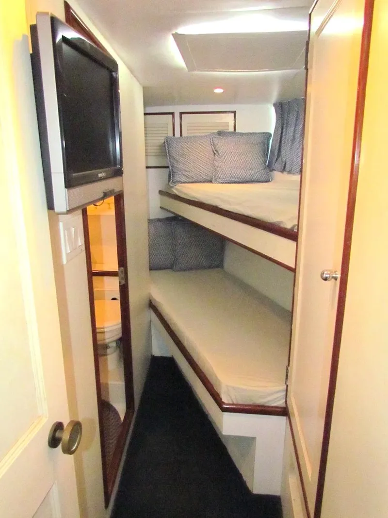 Slide: The Image of Interior of 1972 Hargrave 67 Motor Yacht with bunk beds and TV. - 28