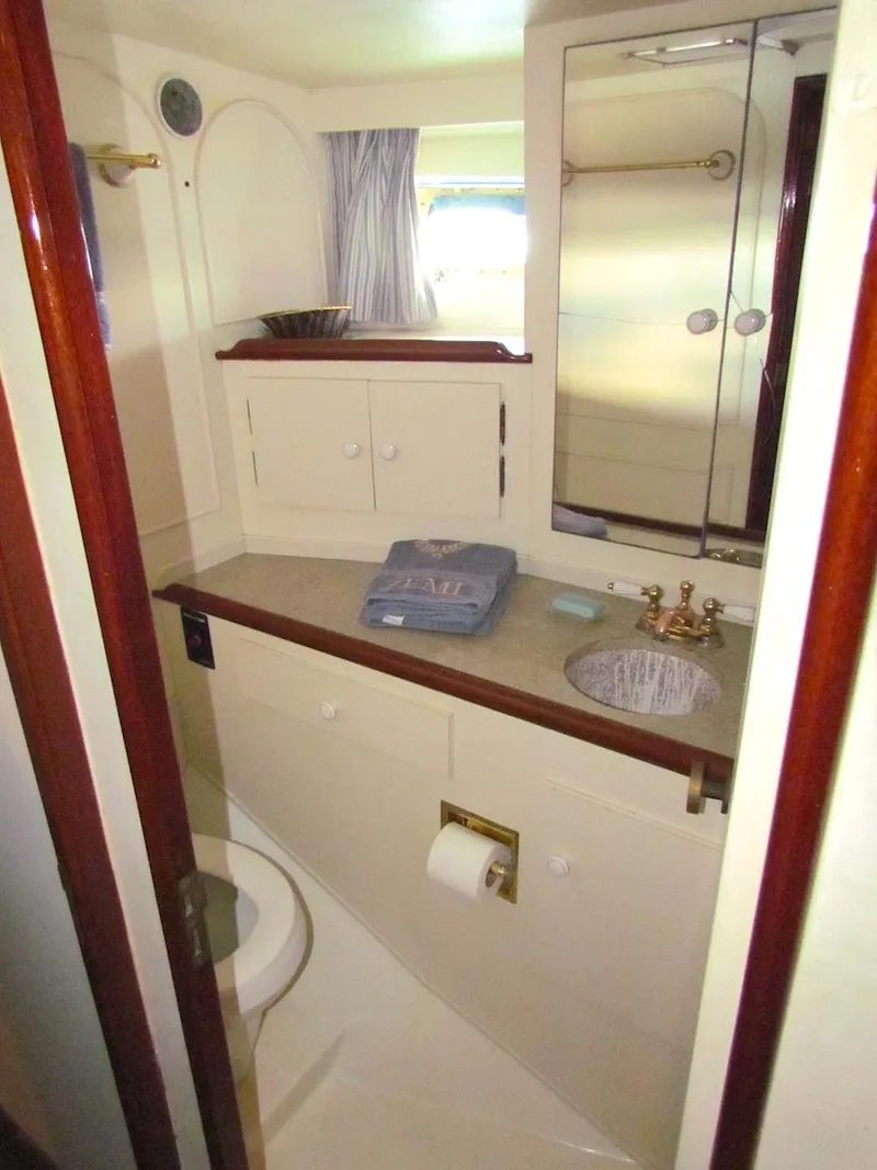 Slide: The Image of 1972 Hargrave 67 Motor Yacht bathroom with sink, mirror, and storage cabinets. - 29