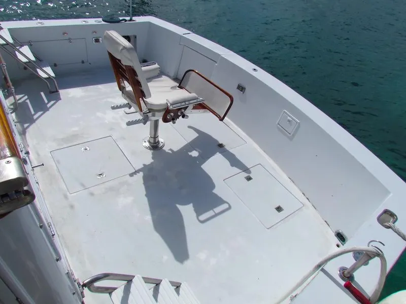 Slide: The Image of 1972 Hargrave 67 Motor Yacht deck with fishing chair, overlooking calm water. - 5