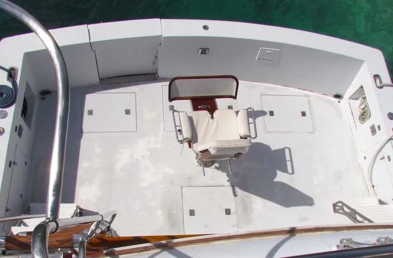 Slide: The Image of 1972 Hargrave 67 Motor Yacht deck with central chair and storage compartments. - 7