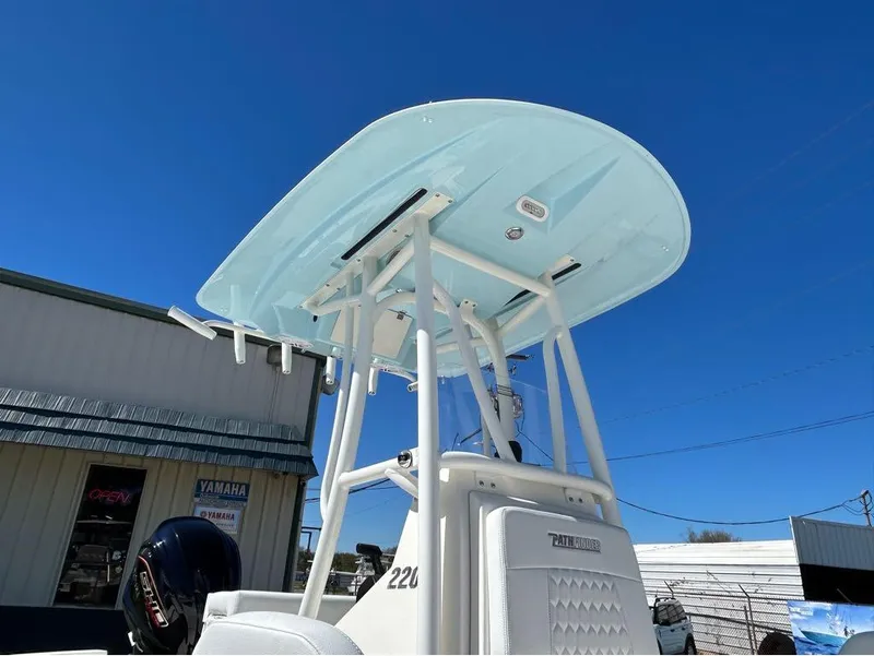 Slide: The Image of 2025 Pathfinder 2200 TRS boat with T-top under clear blue sky. - 3