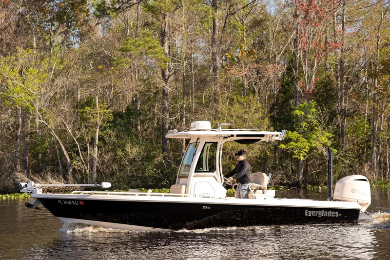 The Image of 2017 Everglades 253 Center Console boat cruising on a scenic river. - 1