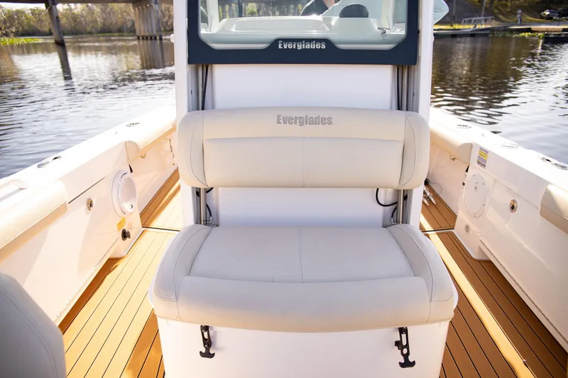 Slide: The Image of 2017 Everglades 253 Center Console boat interior with cushioned seating and teak flooring. - 11