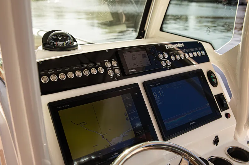 Slide: The Image of 2017 Everglades 253 Center Console dashboard with navigation screens and controls. - 14
