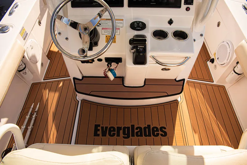 Slide: The Image of 2017 Everglades 253 Center Console boat interior with wood flooring and steering wheel. - 16
