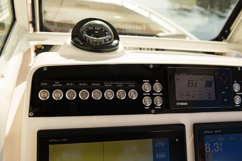 Slide: The Image of Control panel of 2017 Everglades 253 Center Console boat with compass and navigation instruments. - 18