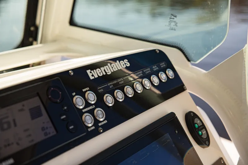 Slide: The Image of Control panel of 2017 Everglades 253 Center Console boat with buttons and display. - 19